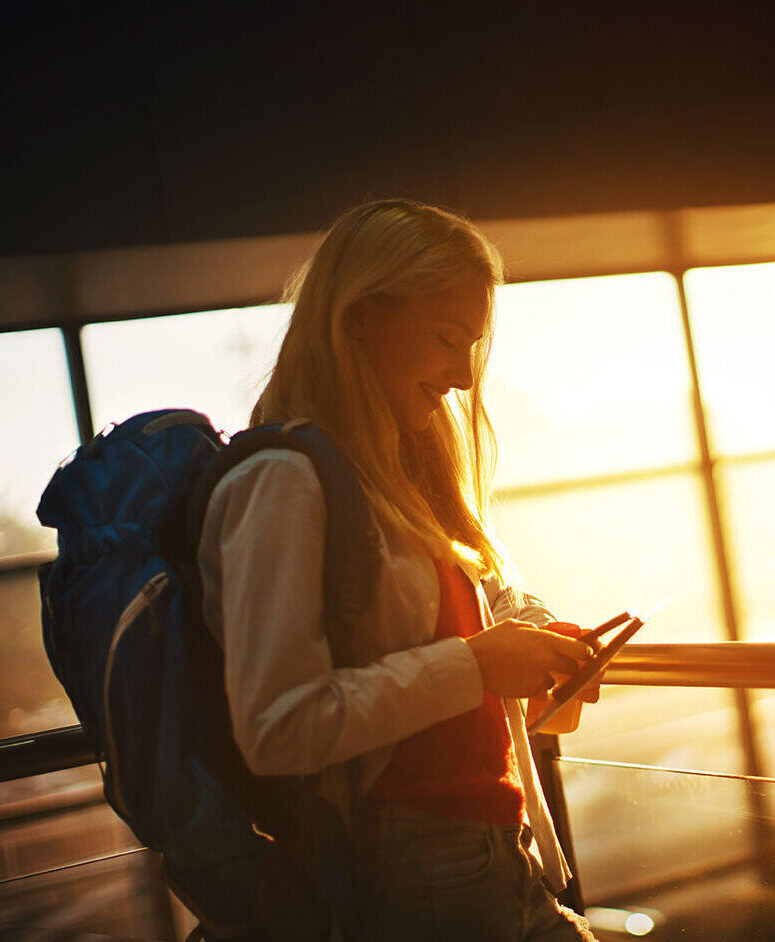 Female traveller checking her phone at airport