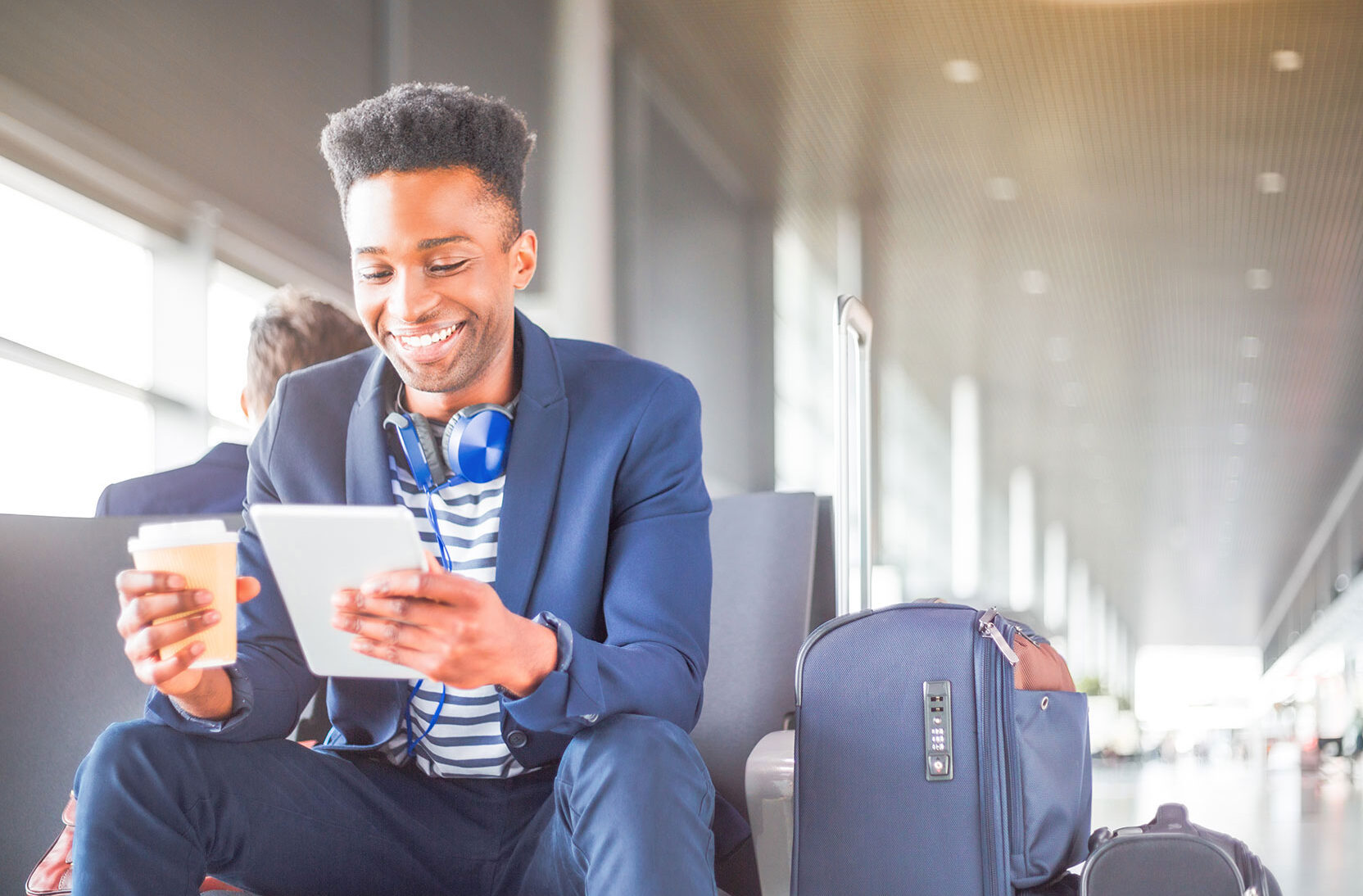 Young man using a digital tablet at airport