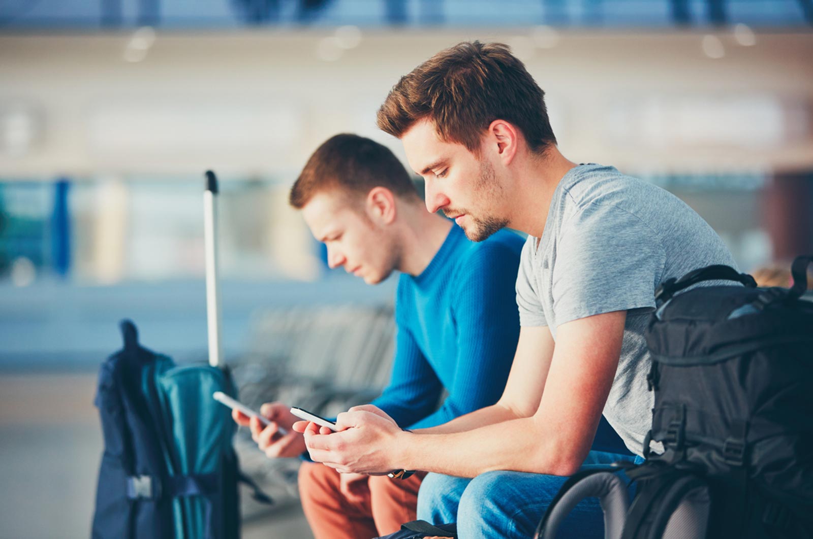 Two male travellers at airport